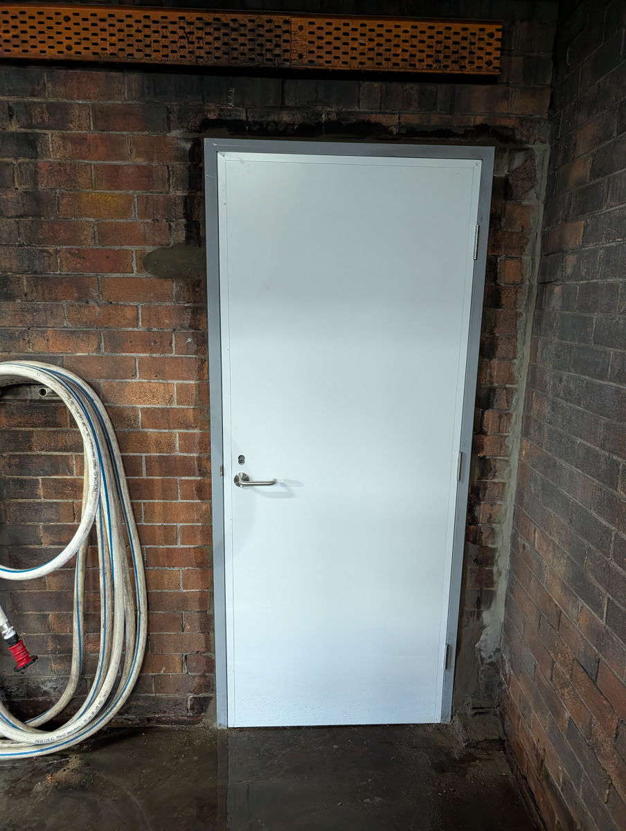 Fire door with a fire-rated vision panel during installation